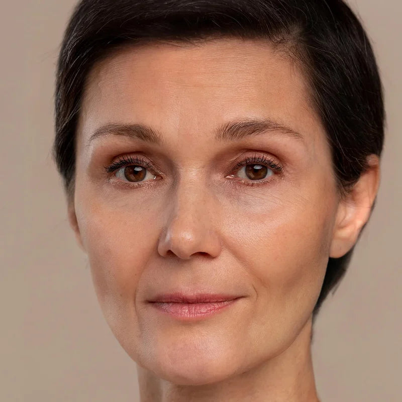 Close-up of a woman with smooth, glowing skin after using SOAH shower filter