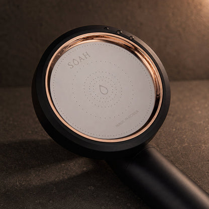 Close-up of the SOAH Black Edition spray face showing the precision nozzles, rose gold bezel and Made in Korea marking.