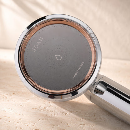 Close-up of the SOAH Chrome Edition spray face showing the micro-perforations, rose gold ring and Made in Korea engraving.