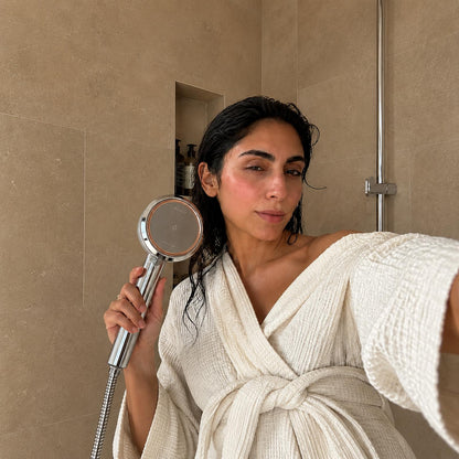 Person using the SOAH Chrome Edition in a modern Dubai bathroom as part of a daily hair and skincare routine.