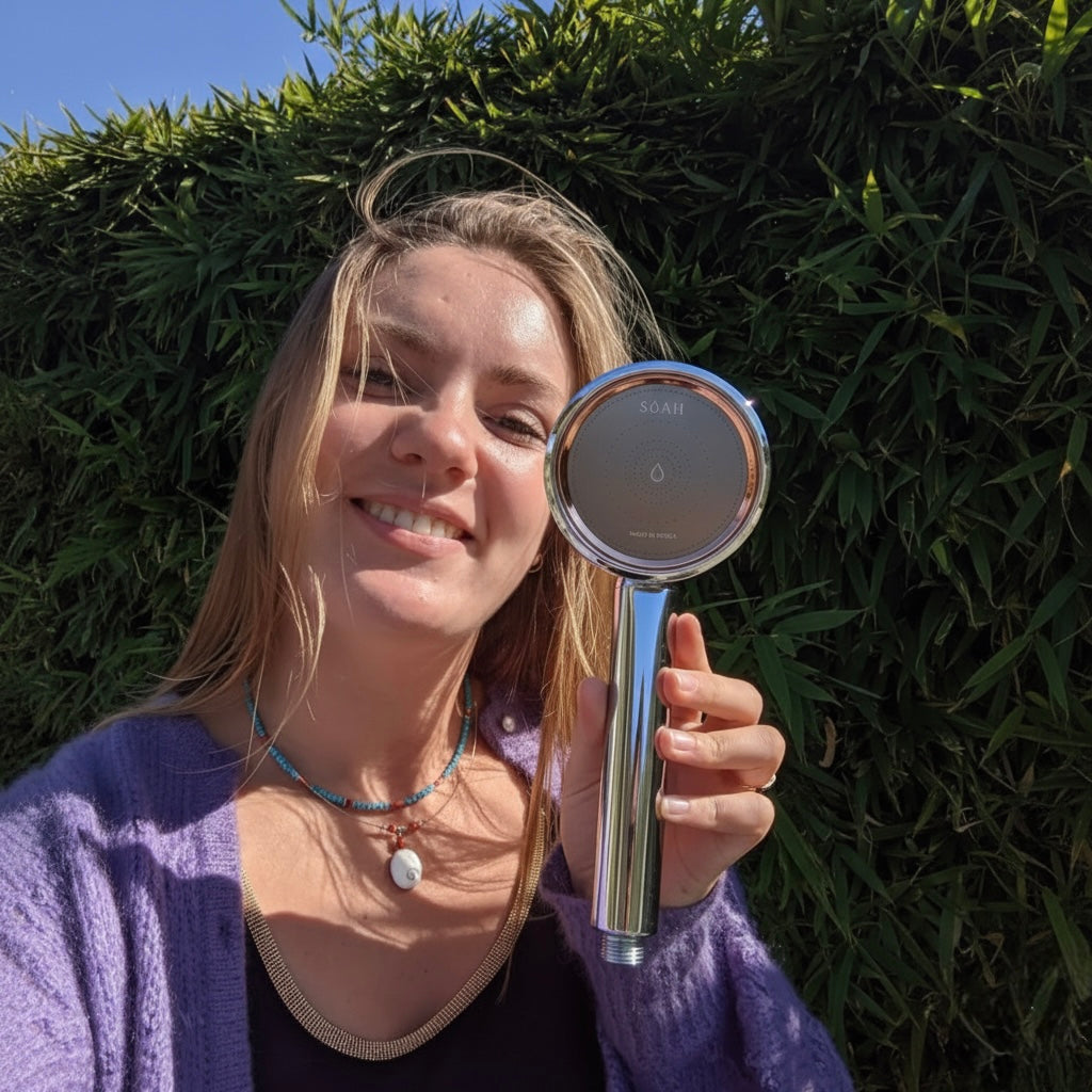 Smiling woman with glowing skin after showering with SOAH Chrome Edition vitamin C shower head