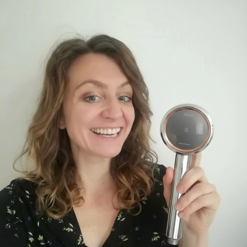 Happy female customer smiling while sharing her review of the SOAH luxury shower head