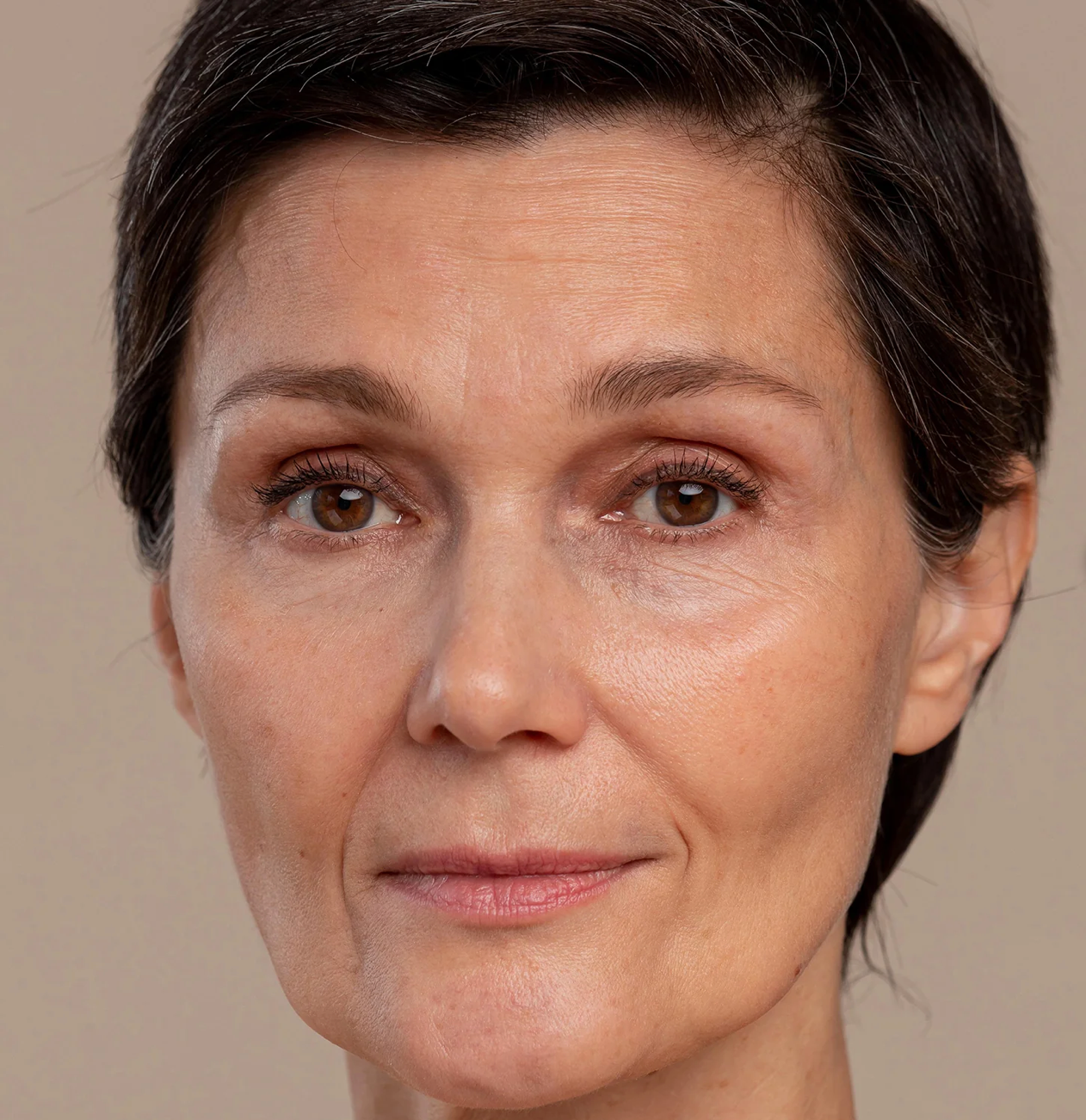Close-up of a woman’s face before using SOAH shower filter, dull skin visible
